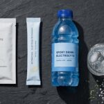 LMNT vs Gatorade vs Liquid I.V. electrolyte powder packets and sports drinks compared on a slate background.